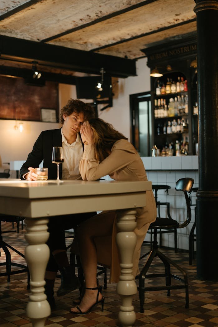 portfolio-img-02 A couple in a restaurant having a tense moment, expressing emotion and stress.